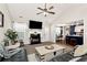 Inviting living room with a cozy fireplace, vaulted ceilings, and seamless flow to dining area at 540 Windermere Dr, Loganville, GA 30052