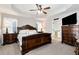 Spacious main bedroom with tray ceiling, ceiling fan, and hardwood furniture at 540 Windermere Dr, Loganville, GA 30052