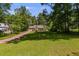 Inviting ranch home with a spacious front yard and mature trees, offering a serene suburban setting with a long driveway at 261 Township Dr, Hiram, GA 30141