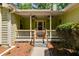 Covered front porch with ceiling fans and a fenced entry, offering a cozy and inviting entrance to this charming home at 261 Township Dr, Hiram, GA 30141