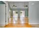 Open-concept living space with hardwood floors, a vaulted ceiling, and French doors leading to an outdoor deck for seamless indoor-outdoor living at 261 Township Dr, Hiram, GA 30141