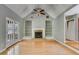 Bright living room featuring a vaulted ceiling, fireplace with built-in bookshelves, and beautiful hardwood floors and French doors at 261 Township Dr, Hiram, GA 30141