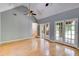 Spacious living room with vaulted ceiling, wood floors, and French doors, filled with natural light, creating a warm atmosphere at 261 Township Dr, Hiram, GA 30141
