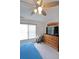 Comfortable bedroom with a ceiling fan, dresser, and large window at 2892 Motts Cove Holw, Lawrenceville, GA 30043