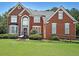 Spacious two-story brick home with a well-manicured lawn and attractive landscaping at 2892 Motts Cove Holw, Lawrenceville, GA 30043
