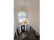 Elegant foyer showcasing a stunning chandelier and hardwood floors at 2892 Motts Cove Holw, Lawrenceville, GA 30043