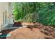 Backyard with a patio featuring an outdoor dining set and natural landscape at 3174 Vickery Ne Dr, Marietta, GA 30066