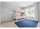 Bright bedroom featuring a white bunk bed, soft carpet, and a window with natural light at 3174 Vickery Ne Dr, Marietta, GA 30066