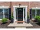 Elegant front entry with a black door, white trim, and manicured landscaping at 3174 Vickery Ne Dr, Marietta, GA 30066