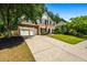 Traditional two-story brick home with a spacious driveway and landscaped front yard at 3174 Vickery Ne Dr, Marietta, GA 30066