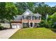 Charming two-story brick home featuring a well-manicured lawn and a two-car garage at 3174 Vickery Ne Dr, Marietta, GA 30066