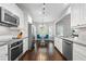 Bright kitchen with white cabinetry, stainless appliances, granite counters and a view into the dining area at 3174 Vickery Ne Dr, Marietta, GA 30066