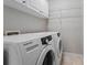 Efficient laundry area with side-by-side washer and dryer and storage cabinets at 3174 Vickery Ne Dr, Marietta, GA 30066