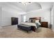 Spacious main bedroom with tray ceiling, neutral carpet, stylish furniture and decor, plus natural light at 3174 Vickery Ne Dr, Marietta, GA 30066