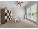Cozy playroom with a ceiling fan, natural light, and carpeted flooring at 3174 Vickery Ne Dr, Marietta, GA 30066