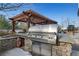 Outdoor grill area featuring a stainless steel grill, stone countertop, pergola, and patio seating at 3300 Windy Ridge Se Pkwy # 1603, Atlanta, GA 30339
