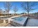 Outdoor hot tub with stone surround offering relaxation and enjoyment amidst a landscaped environment and blue skies at 3300 Windy Ridge Se Pkwy # 1603, Atlanta, GA 30339