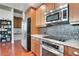 Kitchen features stainless steel appliances, wood cabinets, granite countertops, and mosaic tile backsplash at 3300 Windy Ridge Se Pkwy # 1603, Atlanta, GA 30339