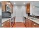 Galley kitchen features wood cabinets, granite countertops, stainless steel appliances, and mosaic tile backsplash at 3300 Windy Ridge Se Pkwy # 1603, Atlanta, GA 30339