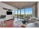 Open living room with floor to ceiling windows, modern furnishings, and beautiful city view at 3300 Windy Ridge Se Pkwy # 1603, Atlanta, GA 30339