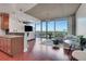Open concept living room seamlessly connects to kitchen area with floor-to-ceiling windows showcasing city views at 3300 Windy Ridge Se Pkwy # 1603, Atlanta, GA 30339