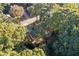 An aerial view of a home nestled among lush green trees, creating a private and serene setting at 4045 White Oak Sw Ln, Lilburn, GA 30047