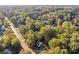 A birds eye view of a home enveloped by mature trees in a quiet neighborhood setting at 4045 White Oak Sw Ln, Lilburn, GA 30047