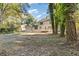 A view of the home's large backyard with mature trees and well-maintained grass at 4045 White Oak Sw Ln, Lilburn, GA 30047