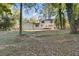 A view of the expansive backyard with the rear of the two-story house at 4045 White Oak Sw Ln, Lilburn, GA 30047