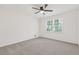 Bedroom featuring new carpet, fresh paint, ceiling fan, and filled with natural light from the large window at 4045 White Oak Sw Ln, Lilburn, GA 30047