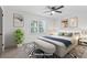 A staged bedroom with new carpet, fresh paint, ceiling fan, and filled with natural light at 4045 White Oak Sw Ln, Lilburn, GA 30047