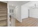Bright entryway features luxury vinyl flooring, a white stair rail, crown molding, and an adjacent dining room at 4045 White Oak Sw Ln, Lilburn, GA 30047