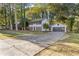 Charming two-story home features a well-manicured lawn, fresh paint, shutters, and an attached two-car garage at 4045 White Oak Sw Ln, Lilburn, GA 30047