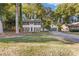 Charming two-story home features a well-manicured lawn, fresh paint, shutters, and an attached two-car garage at 4045 White Oak Sw Ln, Lilburn, GA 30047