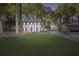 Charming two-story home features a well-manicured lawn, fresh paint, shutters, and an attached two-car garage at 4045 White Oak Sw Ln, Lilburn, GA 30047