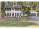 Charming two-story home features a well-manicured lawn, fresh paint, shutters, and an attached two-car garage at 4045 White Oak Sw Ln, Lilburn, GA 30047