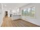 Open kitchen with breakfast bar, stainless steel appliances, and eat-in area with abundant natural light at 4045 White Oak Sw Ln, Lilburn, GA 30047