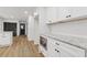 Bright kitchen with white cabinets, subway tile backsplash, stainless steel microwave and granite countertops at 4045 White Oak Sw Ln, Lilburn, GA 30047