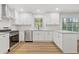 Modern kitchen featuring stainless appliances, granite countertops, and white cabinetry at 4045 White Oak Sw Ln, Lilburn, GA 30047