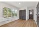 Eat-in kitchen area featuring a large window with natural light, wood-look floors, and door to the outside at 4045 White Oak Sw Ln, Lilburn, GA 30047