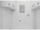 Utility area features white walls and cabinets with electrical and plumbing hookups for appliances at 4045 White Oak Sw Ln, Lilburn, GA 30047