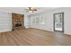 Living room featuring a stone fireplace, custom built-ins, and luxury vinyl plank flooring at 4045 White Oak Sw Ln, Lilburn, GA 30047