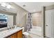 Bathroom showcasing a vanity with double sinks and a shower-tub combo with patterned curtain at 505 Rendezvous Rd, Acworth, GA 30102