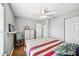 Bedroom with wood floors, closet, ceiling fan, and a shelf displaying decor art pieces at 505 Rendezvous Rd, Acworth, GA 30102