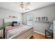Bedroom with natural light, wood floors, a ceiling fan, and decorative wall hangings at 505 Rendezvous Rd, Acworth, GA 30102