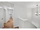Upstairs hallway with wood floors, white trim, and doors leading to various rooms at 505 Rendezvous Rd, Acworth, GA 30102