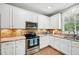 Well-equipped kitchen featuring stainless steel appliances, granite countertops, and ample storage at 505 Rendezvous Rd, Acworth, GA 30102
