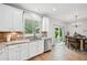 Bright kitchen features white cabinets, stainless steel appliances, and a view of the backyard at 505 Rendezvous Rd, Acworth, GA 30102