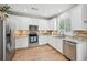 Modern kitchen showcasing stainless steel appliances, white cabinets, and granite countertops at 505 Rendezvous Rd, Acworth, GA 30102