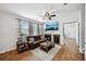 Cozy living room boasts a fireplace, ceiling fan, and large windows for ample natural light at 505 Rendezvous Rd, Acworth, GA 30102